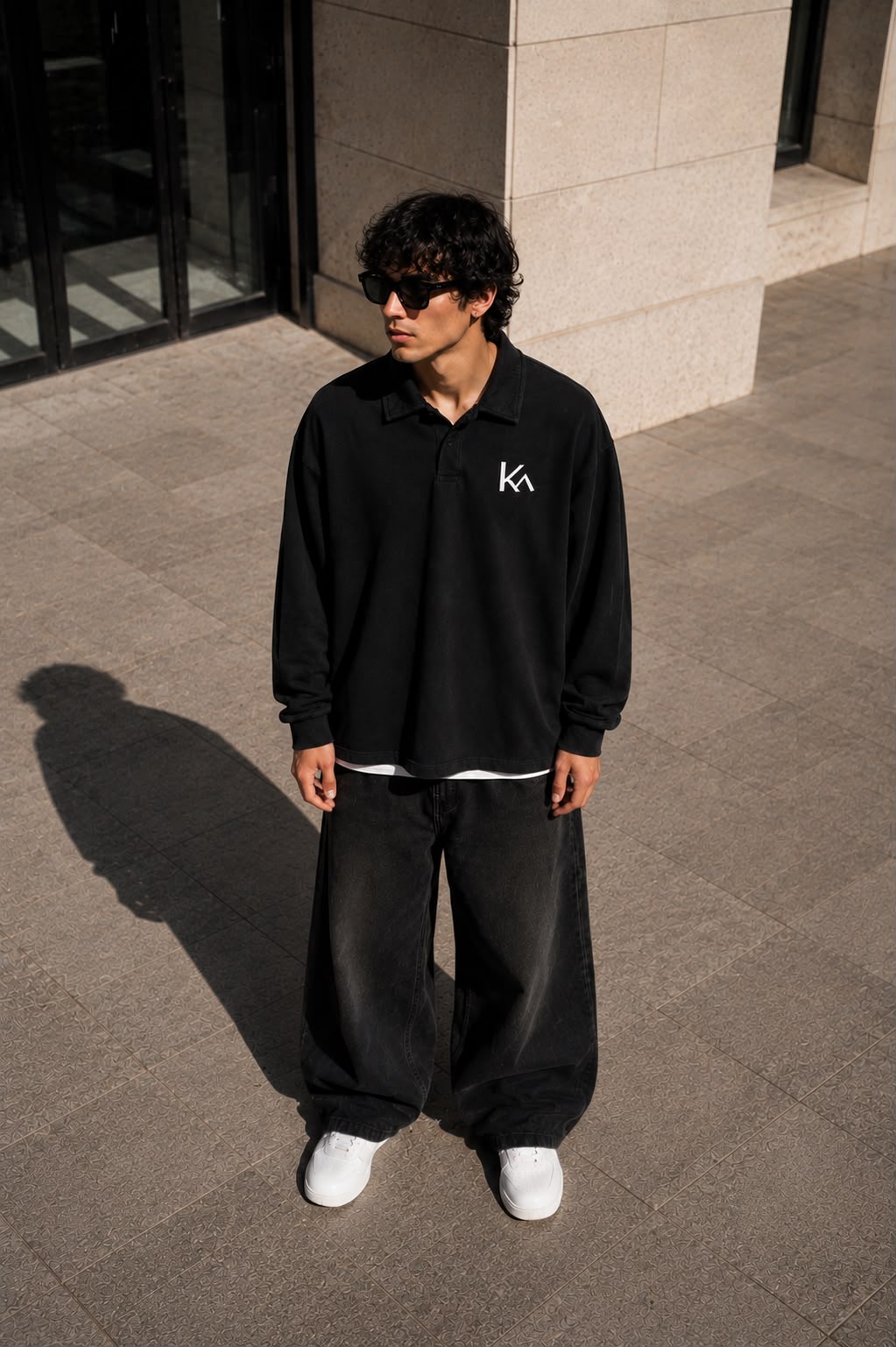KEY ATELIER Loose Long Sleeve Polo Shirt in Black – side or styling view